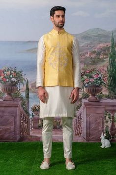 Yellow bundi featuring floral embroidery with zari, pearl, sequin embellishments. Paired with an inner kurta and pant., Fit: Relaxed Festive Designer Nehru Jacket With Chikankari Embroidery, Designer Wear Semi-stitched Chanderi Nehru Jacket, Designer Chanderi Nehru Jacket Semi-stitched, Designer Chanderi Semi-stitched Nehru Jacket, Chanderi Nehru Jacket For Designer Wear And Festive, Festive Designer Wear Chanderi Nehru Jacket, Festive Chanderi Nehru Jacket For Designer Wear, Bollywood Style Floral Embroidered Chanderi Nehru Jacket, Eid Nehru Jacket With Zari Work In Raw Silk