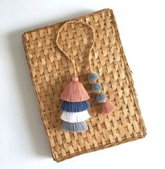 two tassels are hanging from a wicker basket