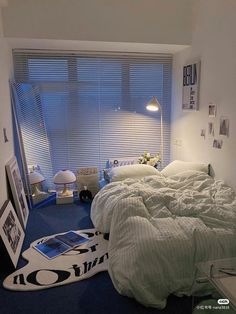 a bed room with a neatly made bed and pictures on the wall next to it