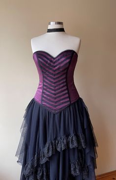 a purple and black corset on a mannequin