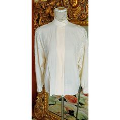 This is an elegant silk blouse from the 80's by Artland.  Made of luxurious ivory silk.  Banded collar.  Rounded shoulder pads.  Both the shoulders are beaded with silver and white glass beads.  Dolman sleeves. Buttons down the front and at the cuffs.  Excellent condition.  Labeled a size 8, however, please see the measurements below for a proper fit.  All sales are final. Measurements Armpit-armpit doubled 45" Length 25" Cream Silk Blouse For Evening, Silk Cream Evening Blouse, Cream Silk Evening Blouse, Elegant Vintage White Tops For Wedding, Classic Cream Party Blouse, Elegant Vintage White Blouse For Wedding, Vintage Cream Blouse For Formal Occasions, Flapper Party, Flapper Style