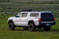 a white truck parked in the middle of a field