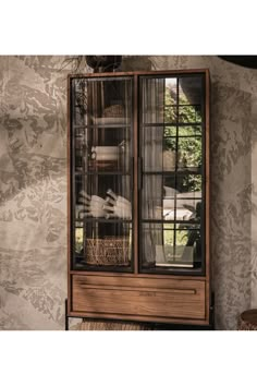 an old fashioned cabinet with glass doors and drawers