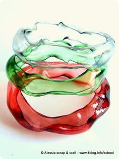 three different colored glass bowls stacked on top of each other in the shape of waves