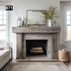 a living room with a fire place in the middle and a mirror on top of it