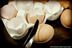 an assortment of eggs in a carton with a spoon