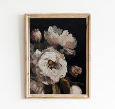 an oil painting of white and pink flowers on a black background in a gold frame