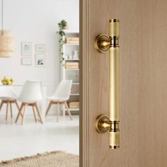 an open door with a handle on it in front of a dining room table and chairs