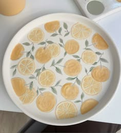 a white plate with lemons painted on it