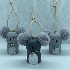 three little koalas are hanging from twine