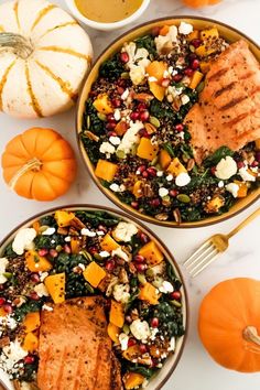 two bowls filled with food next to some pumpkins