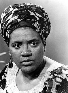 a black and white photo of a woman wearing a turban