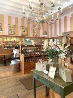 the inside of a store filled with lots of items and flowers on top of a table