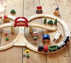 a wooden toy train set sitting on top of a wooden floor