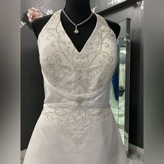 a white dress on display in front of a mirror