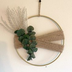 a circle with some plants on top of it and two sticks sticking out of the middle