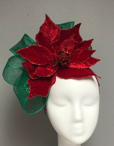 a white mannequin head with red and green flowers on it