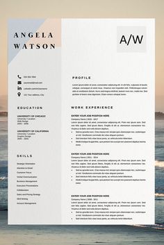 a white and black resume is on display in front of the ocean