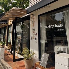 the outside of a building that has been converted into a restaurant with windows and awnings