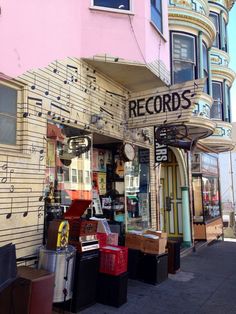 an old record store with musical notes on the side of it's front door