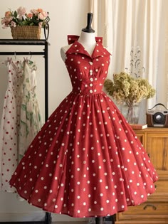 This price includes a dress, a big bow pin and a bowknot hairclip (not for sale).  This stunning piece features a captivating polka dots print that exudes vintage charm. The dress is designed with a halter neck that gracefully ties into a big bow at the back, the backless design is complemented by an elasticated back and adjustable lace-up,   	 		 			Size 			S 			M 			L 			XL 			2XL 		 		 			Waist 			60-68 			66-74 			72-80 			78-86 			84-92 		 		 			Full Length 			112 			114 			116 			118 			12 Fit And Flare Dress Retro, 1950 Bow Dress, Cheap Red Heart Print Dress, 50s Dresses Vintage Pinup With Jewelry, Vintage Red Dress Modcloth, Retro Dress Print, Red Poke Dot Dress, Retro Inspired Dresses, Dapper Day Dress