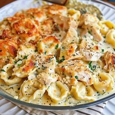 pasta with chicken and parmesan cheese in a glass bowl on a white plate