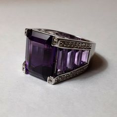 New. Magnificent Cuts And Color To This Beautiful Amethyst Ring. The Color Of Royalty Fit For A Queen. If You Have The Ovals And The Rounds, Then Grab This One To Add To Your Collection. Bought From A Home Shopping Network In The United States. Invest In Quality Jewelry That You Will Love To Give As A Gift Or Own Yourself. Classic Amethyst Jewelry With Polished Finish, Classic Polished Amethyst Jewelry, Fine Amethyst Jewelry With Polished Finish, Elegant Amethyst Gemstones With Accent Stones, Silver Amethyst Gemstone Ring In Sterling Silver, Purple Gemstones With Sterling Silver Accents, Luxury Sterling Silver Gemstones, Silver Amethyst Ring In Sterling Silver, Purple Polished Gemstones Fine Jewelry