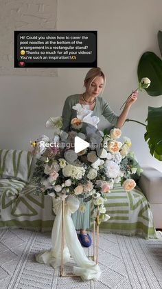 a woman sitting on a couch with flowers in front of her