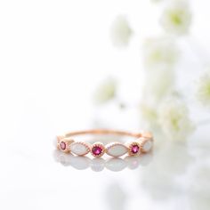 a close up of a ring with flowers in the background