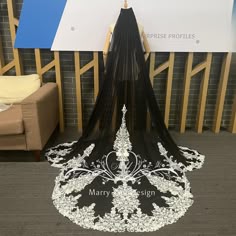 a black and white wedding veil on display in front of a sign that says marry design