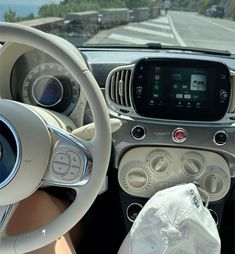 the interior of a car with steering wheel, dashboard and touchscreen display on it