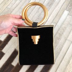 "When vintage looks this modern, it's a great thing. This black and gold evening bag/tiny tote is tres chic. So good with just about anything. Small but interestingly, roomy enough to hold a whole bunch cos of the wide roundish base. Measures 5-1/4\" (width) x 6\" (height excluding handles) x 5\" (base width) Condition: Excellent. Minor wear on gold rings. This bag is clean and ready to use. Comes from a smoke and pet free home. Don't forget to follow me on Instagram @tammaraclearshercloset for Modern Gold Clutch With Top Handle, Modern Evening Bag For Party With Top Carry Handle, Modern Evening Bag With Top Carry Handle For Parties, Chic Gold Shoulder Bag With Top Carry Handle, Gold Clutch Evening Bag For Shopping, Chic Gold Shoulder Bag With Handles, Modern Party Clutch With Top Carry Handle, Modern Gold Clutch With Detachable Handle, Chic Gold Evening Bag With Top Handle