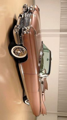 an antique car is hanging on the wall