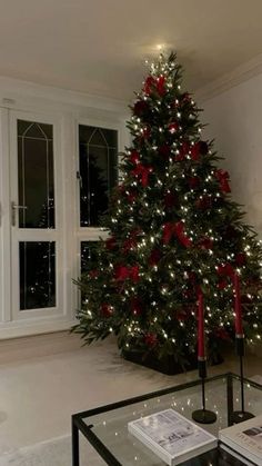 a living room with a christmas tree in the corner