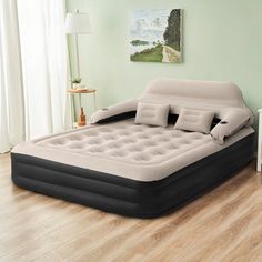 an inflatable bed sitting on top of a hard wood floor