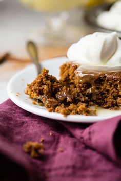 a piece of cake on a plate with whipped cream