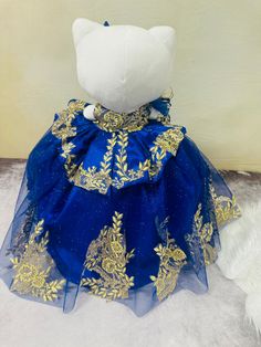 Celebrate your special day with the Hello Kitty Quinceañera dress. Made from tulle and adorned with gold appliques, this dress is fully customizable to help you stand out. Combining elegance and playfulness, this dress is perfect for any Hello Kitty fan looking to make a statement. Royal Blue And Gold Quinceanera Dresses Charro, Blue And Gold Charro Dress, Royal Blue And Gold Quinceanera Crown, Royal Blue Quince Doll, Hello Kitty Gold Jewelry, Gold Applique, Royal Blue And Gold, Quinceanera Dresses, Quinceanera