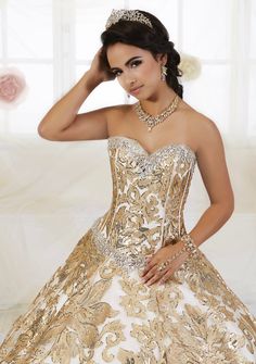 Look unforgettable in this floral sequined A-line dress by House of Wu Quinceanera Collection 26909 during your Quinceanera, Sweet 16 party, or for any formal event. This princess ball gown features a decorative floral sequin pattern. The strapless bodice is accented with statement beading around the sweetheart neckline and waist. This look is finished with lace up back. House of Wu Quinceanera Collection Fall 2018 Style Number: 26909 Fabric: Floral Sequins Colors: Black Gold/Champagne, Gold/Cha Glamorous Quinceanera Gown With Fitted Bodice, Glamorous Quinceanera Dress With Sweetheart Neckline, Glamorous Embellished Quinceanera Dress For Gala, Glamorous Fitted Gown For Quinceanera, Embellished Gold Ball Gown For Quinceanera, Glamorous Fitted Quinceanera Dress For Debutante Ball, Gold Embellished Ball Gown For Quinceanera, Gold Gown With Sweetheart Neckline For Quinceanera, Glamorous Quinceanera Dress With Fitted Bodice