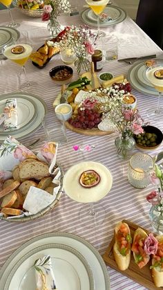 the table is set with plates and bowls of food