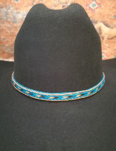 Braided Horse Hair Adjustable Hat Band in Brown/Black, Turquoise/Brown/Black, or Black/Brown/White, with 2 sliding knots make this hatband a great fit for most hats. This stunning hat band is made from genuine braided horse hair and will compliment your favorite cowboy hat.   - 3 braided strands are sewn together to create this gorgeous hatband. - Hat band measurements: approximately adjusts to 27.5" around and is 3/8 inch wide - Hat bands are shown on a size 7 hat.  Hats are not included. - See my horse hair KEEPSAKES to have a hat band made from your horse's hair:  https://www.etsy.com/shop/BlueEyesDesignsHB?ref=seller-platform-mcnav§ion_id=43697745 - See my HORSE HAIR hat bands:  https://www.etsy.com/shop/BlueEyesDesignsHB?ref=shop-header-name&listing_id=1296906619&from_page=listing&sec Blue Western Hat For Vacation, Bohemian Blue Hat Bands For Vacation, Bohemian Blue Hat Band For Vacation, Western Blue Hat Bands For Beach, Adjustable Blue Hat Bands For Vacation, Blue Flat Brim Hat Bands For Vacation, Casual Blue Hat Bands For Festivals, Casual Adjustable Turquoise Hats, Turquoise Casual Adjustable Hat