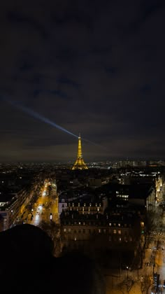 the eiffel tower lit up at night in paris, france with street lights