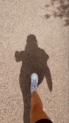 the shadow of a person's leg and shoes