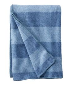 a blue blanket folded on top of a white background