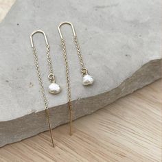 Minimalist Pearl Ear threader earrings, these dainty chain earrings with the perfect touch of femininity and it's great to combine with other earrings or wear alone for a minimalist look.Fun and delicate, these 14k gold-filled threader earrings come with wire bar ends on one side to make it easy to thread the chain through any pierced hole in your ear and on the other side, a small freshwater pearl. Mix and match with other HLcollection earrings for an edgy style statement or wear it on its own Delicate 14k Gold Filled Threader Earrings, Delicate 14k Gold Threader Earrings, Dainty Adjustable Threader Earrings, Yellow Gold Threader Earrings With Pearl Drop, Yellow Gold Long Drop Threader Earrings With Pearl Drop, Minimalist Linear Earrings With Delicate Chain, Minimalist Linear Drop Earrings With Delicate Chain, 14k Gold Long Drop Threader Earrings, Elegant Adjustable 14k Gold Threader Earrings