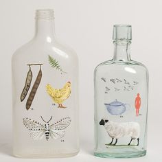 two glass bottles with designs on them and one has a white sheep in the bottom