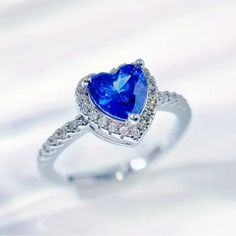 a heart shaped blue sapphire and diamond ring