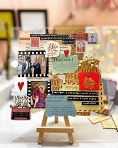 a table topped with lots of different types of cards and pictures on top of a wooden easel