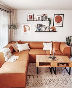 a living room with an l shaped couch and coffee table in front of the window