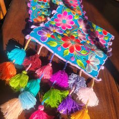 several colorful tassels on a wooden table