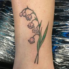 a foot with a flower tattoo on it